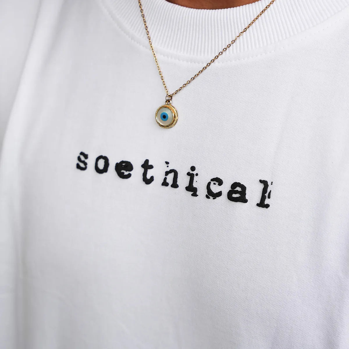 Close-up of 3D Soethical logo on Alter Ego white oversized t-shirt front
