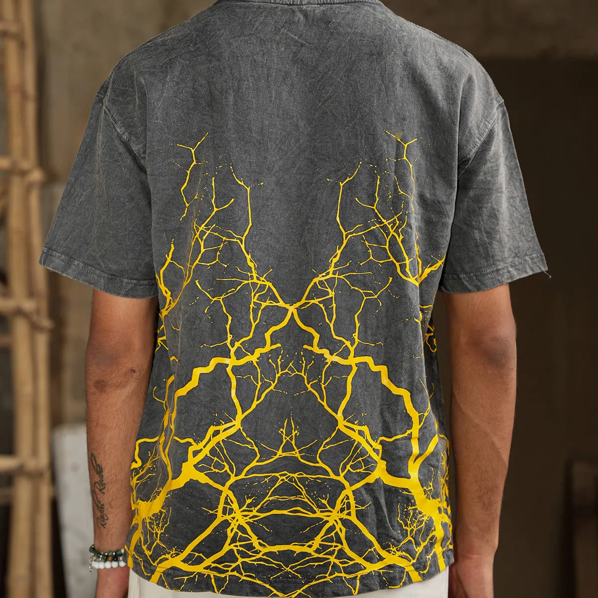 Back view of Roots of Power oversized t-shirt with golden branching graphic print